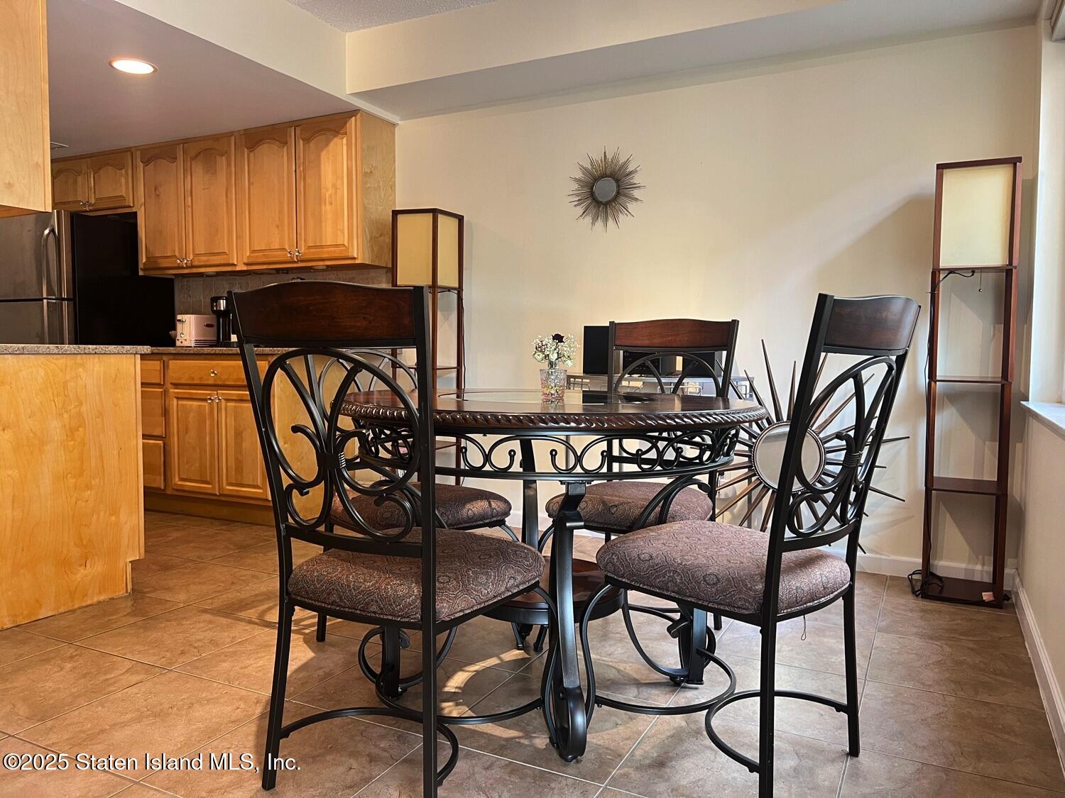 11 Windham Loop, Unit 1NN Staten Island, NY 10314 - Photo 16 of 25 a view of a dining room with furniture and wooden floor