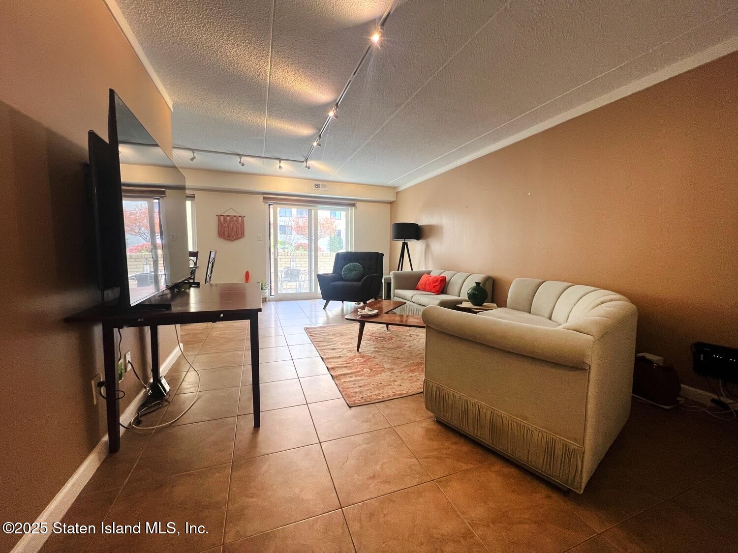 11 Windham Loop, Unit 1NN Staten Island, NY 10314 - Photo 6 of 25 a living room with furniture and a flat screen tv