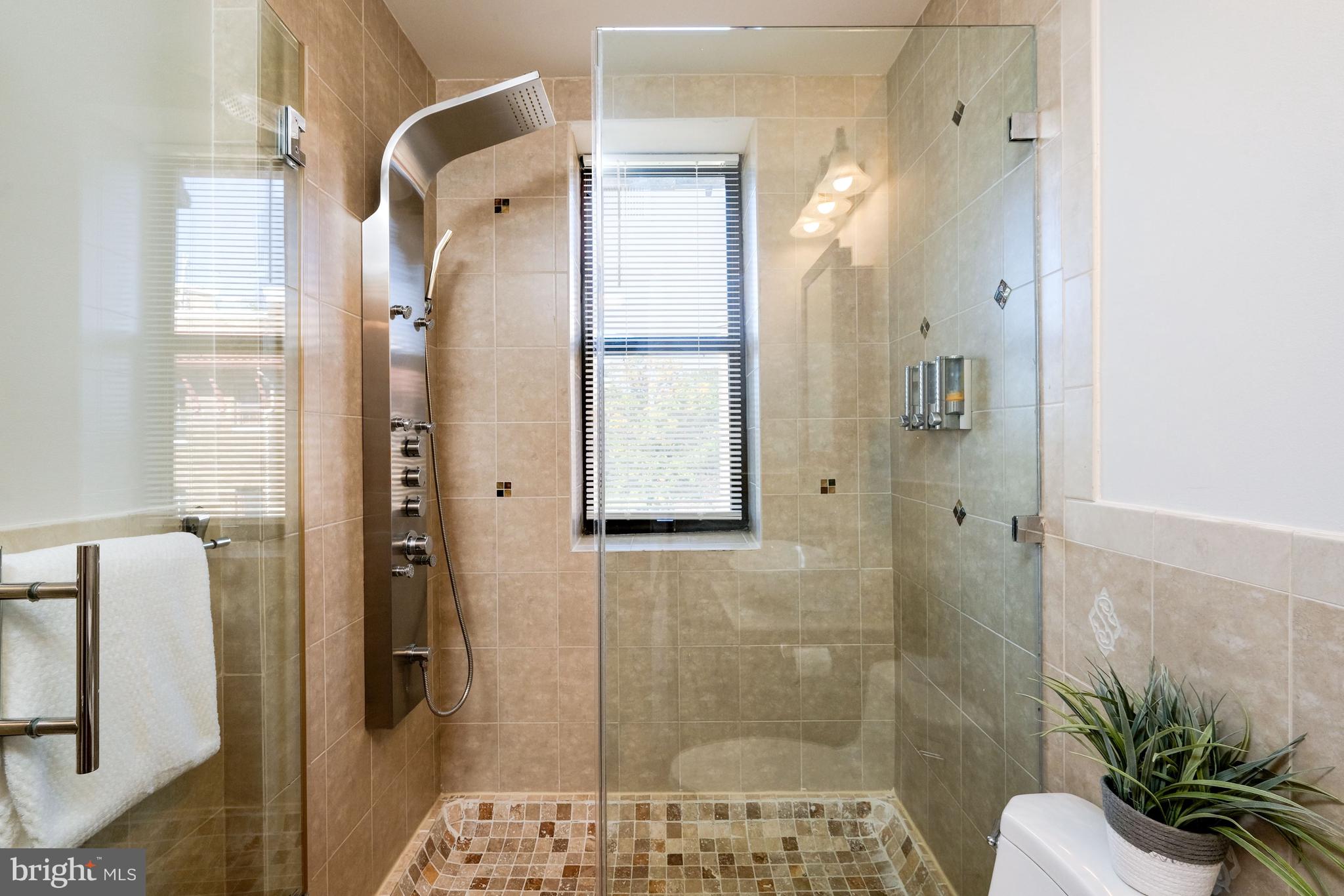 2633 Adams Mill Road Northwest, Unit 401 Washington, DC 20009 - Photo 15 of 27 Luxuriously tiled bathroom