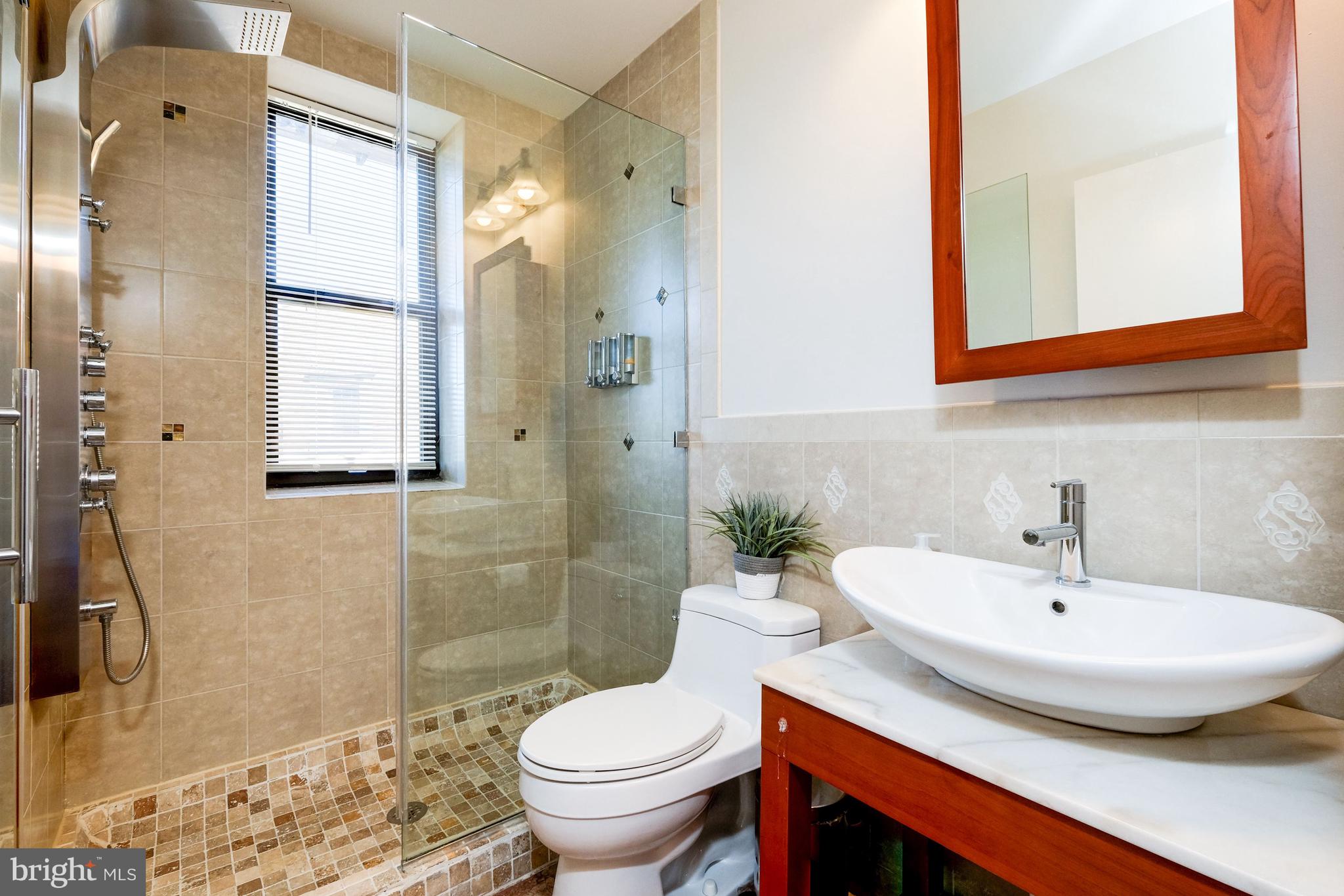 2633 Adams Mill Road Northwest, Unit 401 Washington, DC 20009 - Photo 16 of 27 Luxuriously tiled bathroom