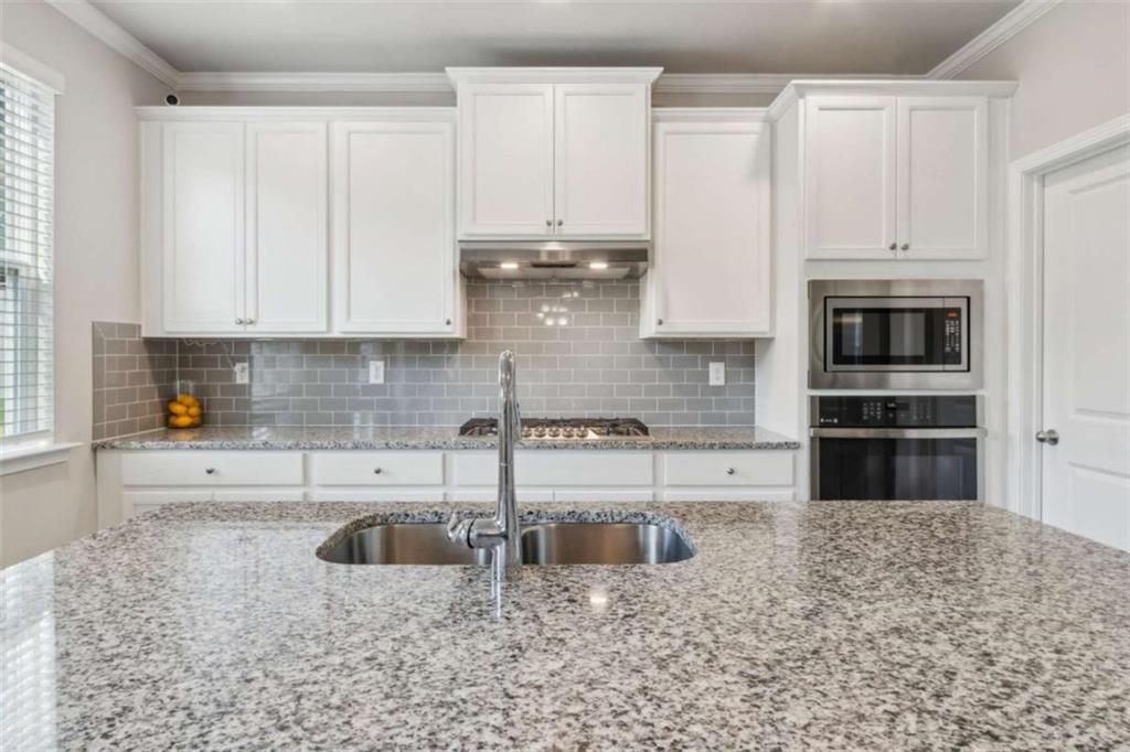 429 Paxton Lane Jefferson, GA 30549 - Photo 24 of 53 a kitchen with stainless steel appliances granite countertop a sink a stove and cabinets