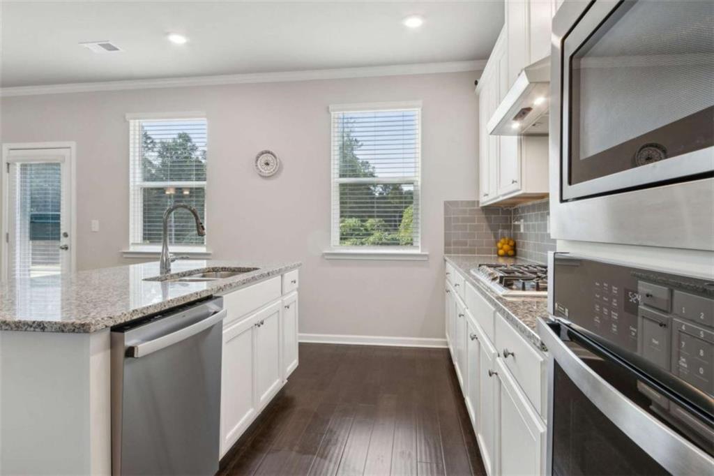 429 Paxton Lane Jefferson, GA 30549 - Photo 27 of 53 a kitchen with granite countertop a stove and a sink