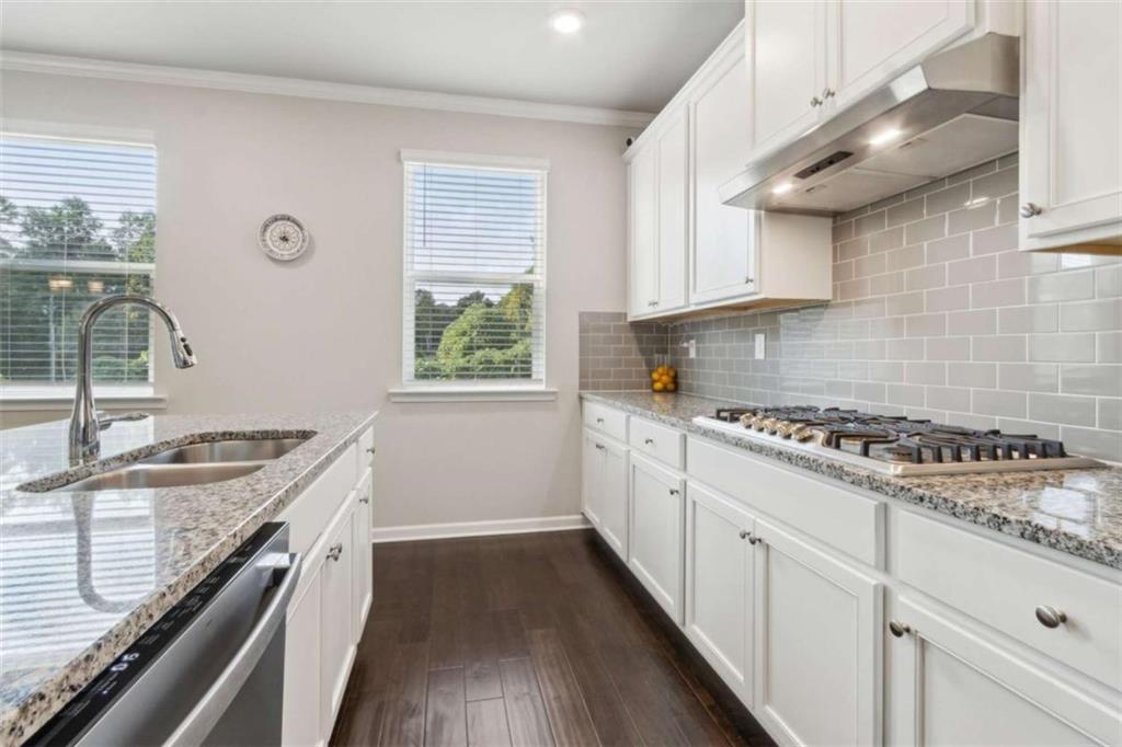 429 Paxton Lane Jefferson, GA 30549 - Photo 28 of 53 a kitchen with a stove a sink a window and cabinets