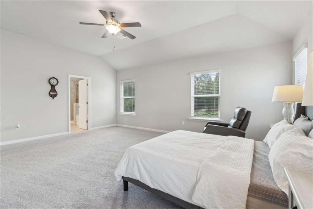 429 Paxton Lane Jefferson, GA 30549 - Photo 33 of 53 a bedroom with a bed and a chandelier