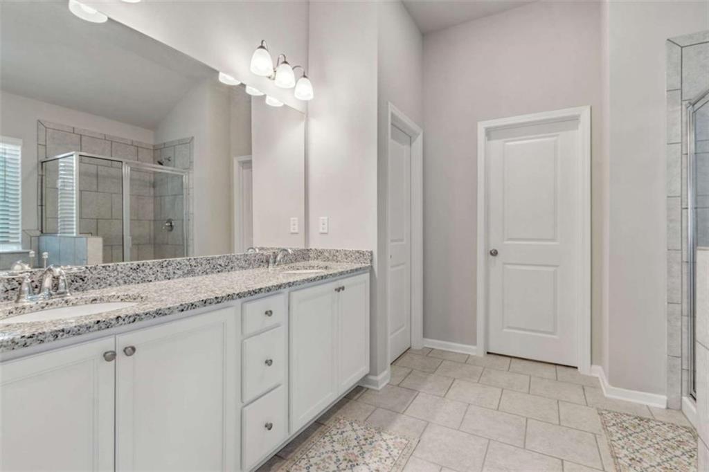 429 Paxton Lane Jefferson, GA 30549 - Photo 35 of 53 a bathroom with a granite countertop sink and a mirror