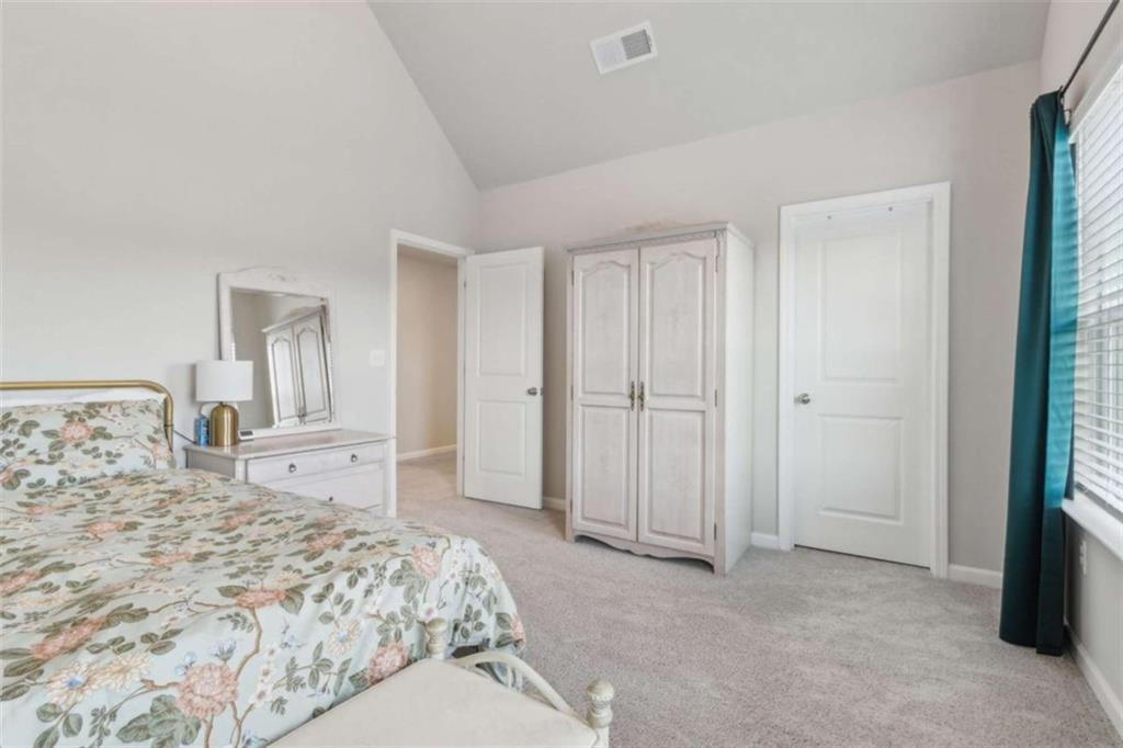 429 Paxton Lane Jefferson, GA 30549 - Photo 40 of 53 a bedroom with a bed and a large mirror
