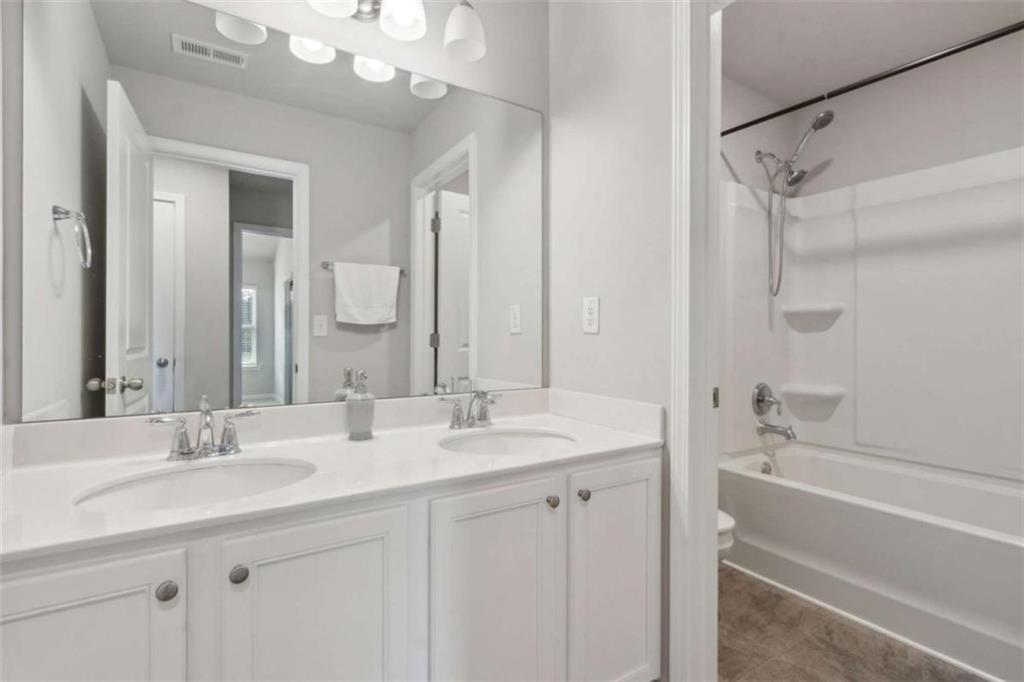 429 Paxton Lane Jefferson, GA 30549 - Photo 44 of 53 a bathroom with a double vanity sink mirror double and bathtub