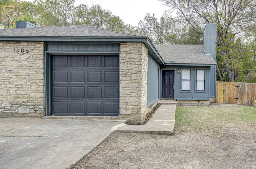 1306 Bonnie Brae Street, Unit B Austin, TX 78753 - Photo 1 of 28 a front view of a house with a yard and garage