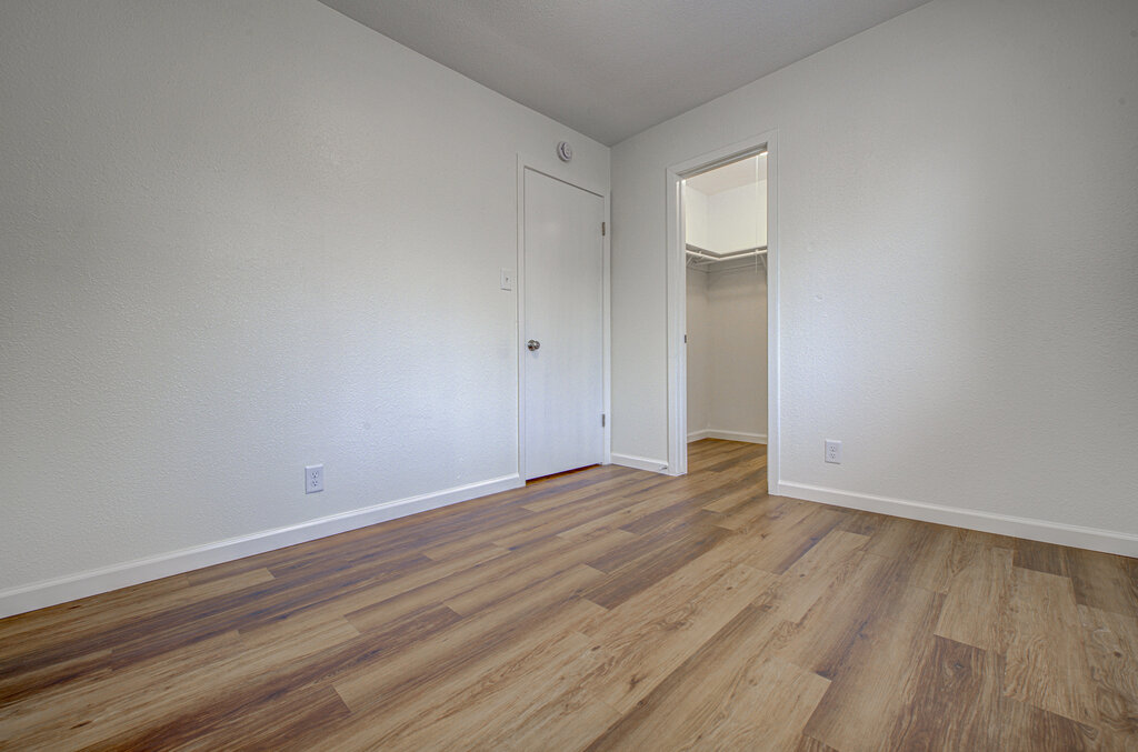 1306 Bonnie Brae Street, Unit B Austin, TX 78753 - Photo 11 of 28 a view of an empty room with wooden floor and a window