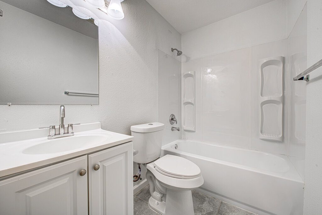 1306 Bonnie Brae Street, Unit B Austin, TX 78753 - Photo 21 of 28 a bathroom with a sink a toilet and shower