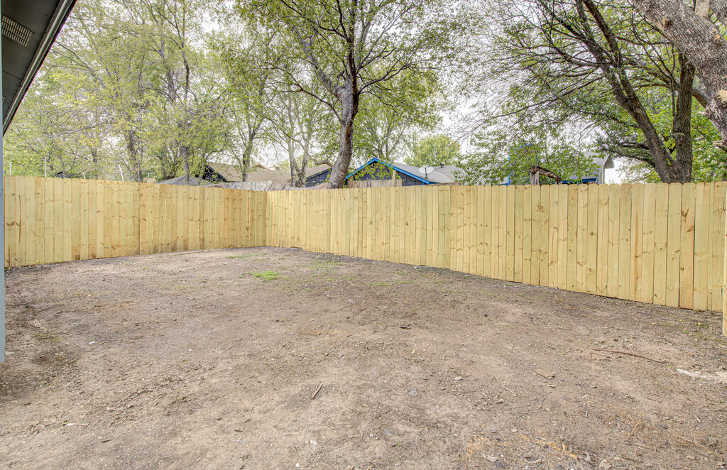 1306 Bonnie Brae Street, Unit B Austin, TX 78753 - Photo 26 of 28 a view of backyard with large trees and wooden fence