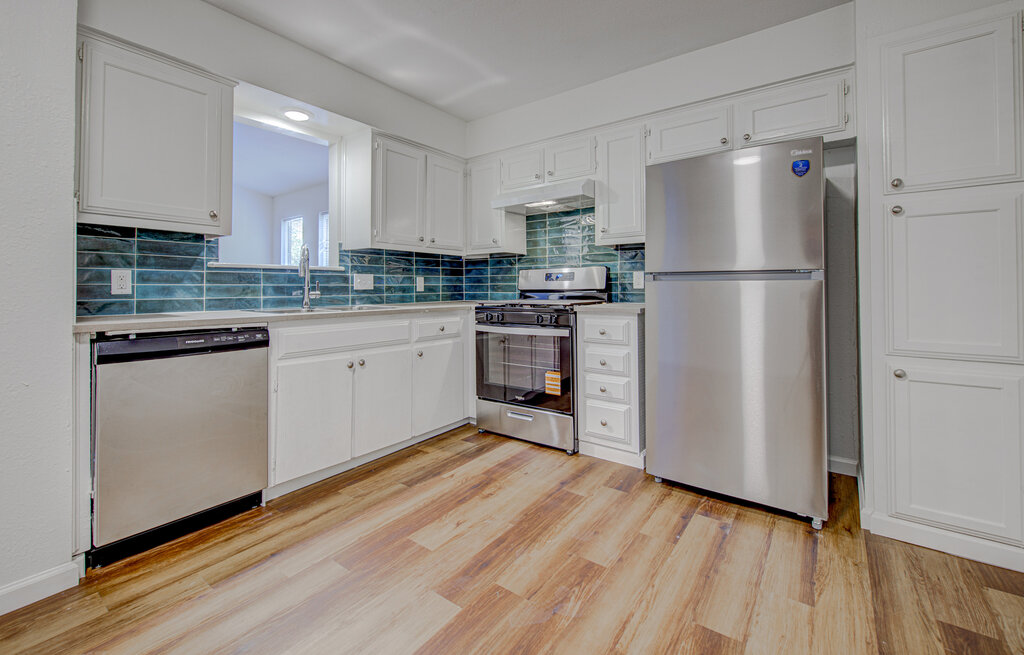 1306 Bonnie Brae Street, Unit B Austin, TX 78753 - Photo 3 of 28 a kitchen with a refrigerator a sink and cabinets