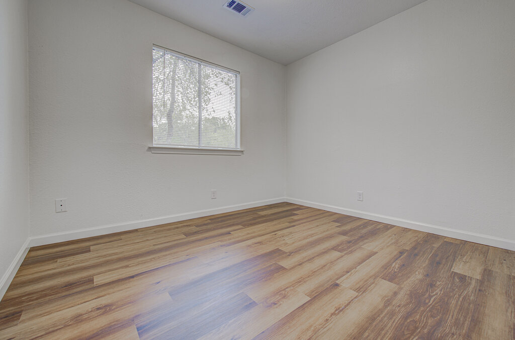 1306 Bonnie Brae Street, Unit B Austin, TX 78753 - Photo 10 of 28 a view of empty room with wooden floor and fan