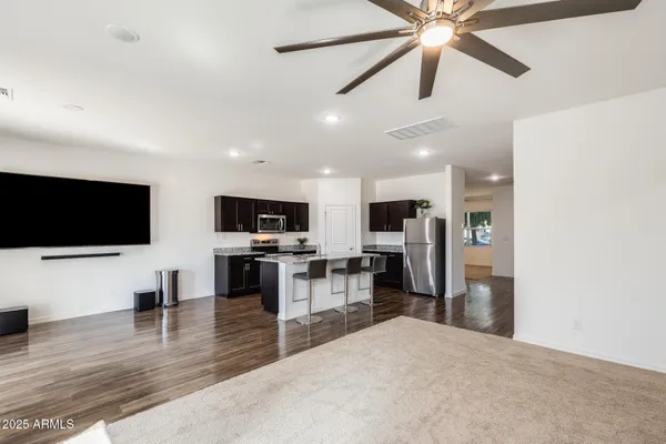 a kitchen with stainless steel appliances granite countertop a sink stove and refrigerator