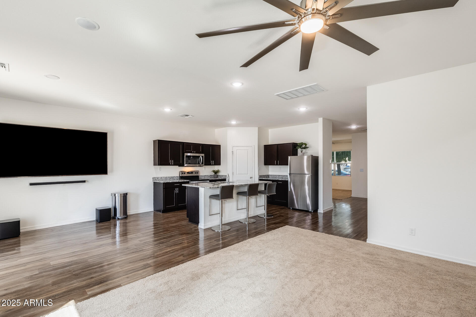 5663 East Moira Road Florence, AZ 85132 - Photo 10 of 37 a view of a living room a flat screen tv and kitchen view