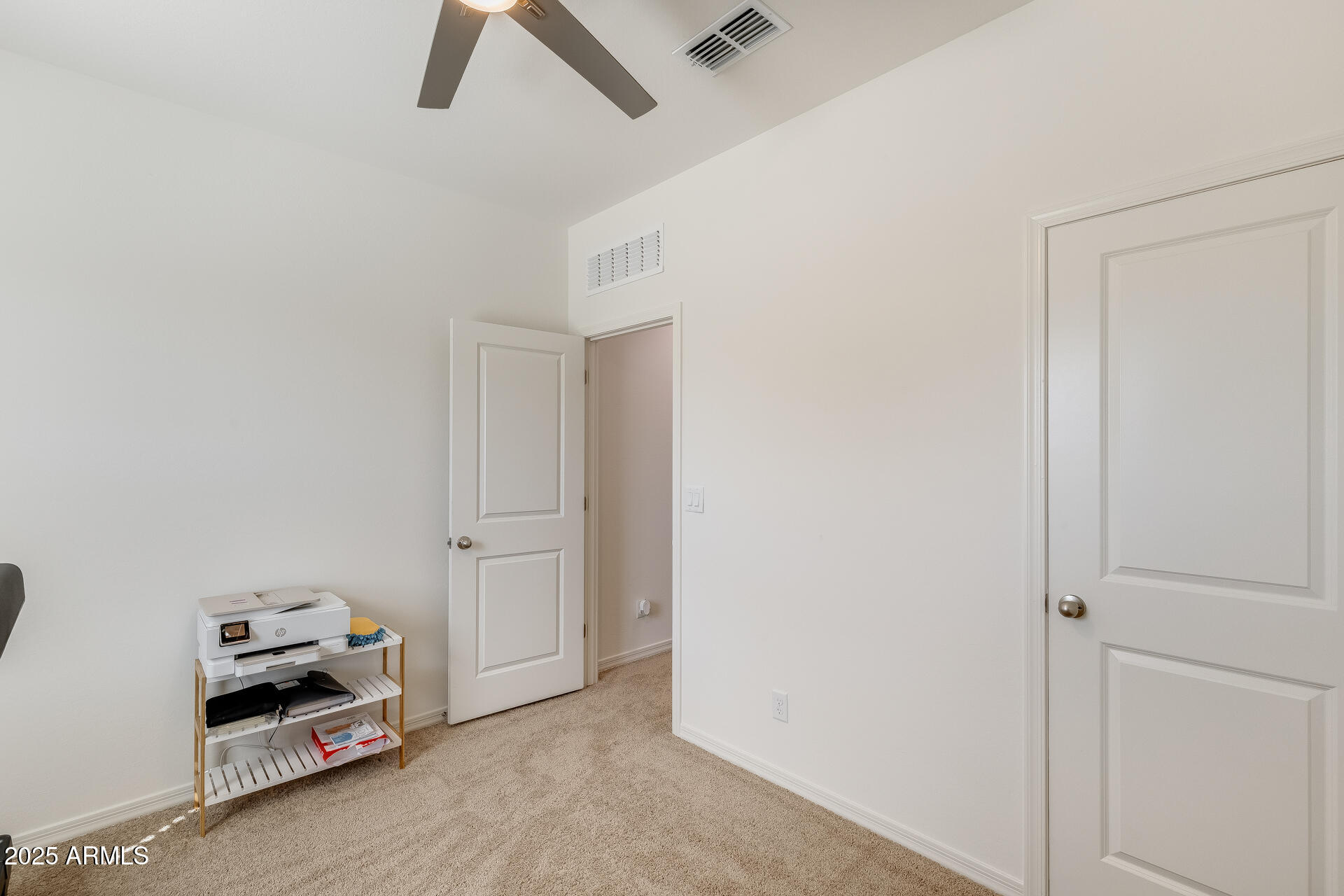 5663 East Moira Road Florence, AZ 85132 - Photo 18 of 37 a bedroom with a bed and a chandelier