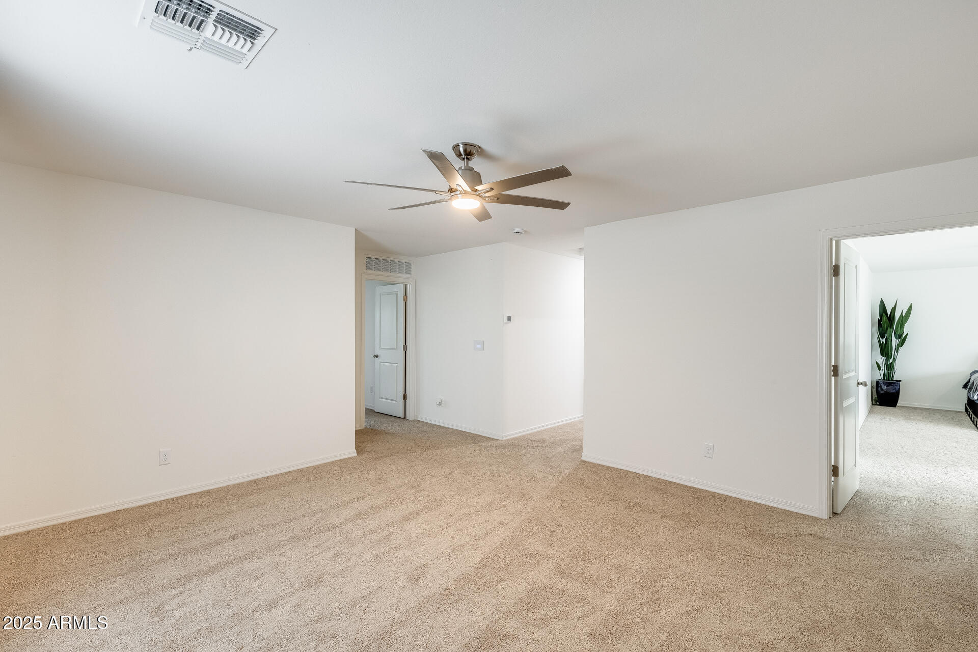 5663 East Moira Road Florence, AZ 85132 - Photo 21 of 37 an empty room with closet and ceiling fan