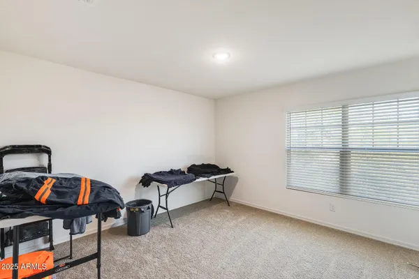 an empty room with closet and ceiling fan