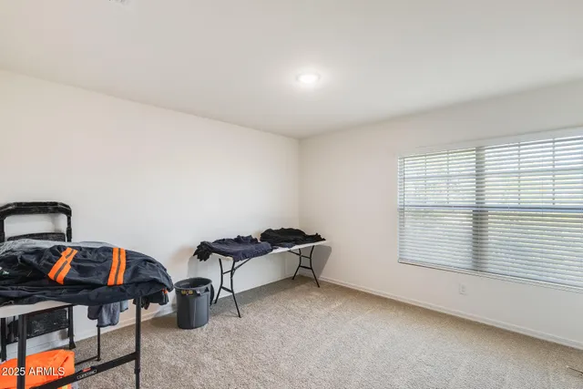 an empty room with closet and ceiling fan