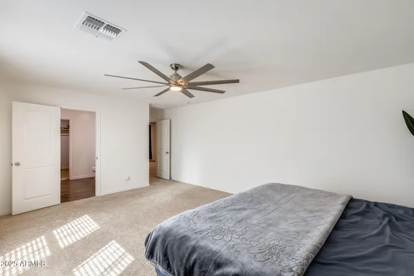a bedroom with a bed and a potted plant