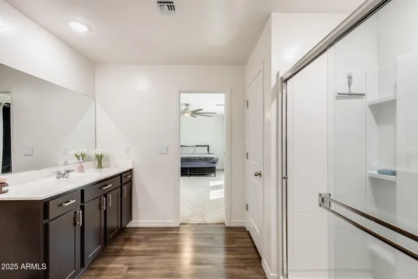 a bathroom with a double vanity sink and a mirror