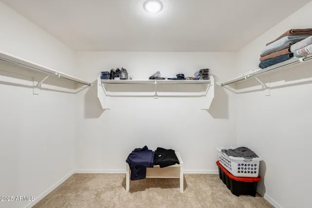 a bathroom with double vanity and a mirror