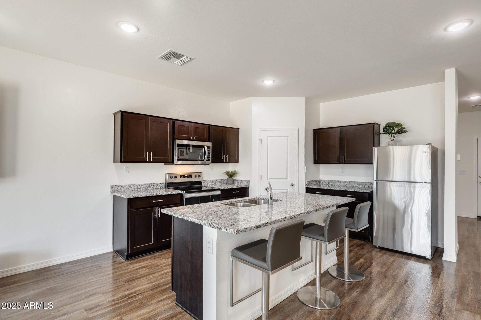 5663 East Moira Road Florence, AZ 85132 - Photo 7 of 37 a kitchen with a stove a sink and a microwave
