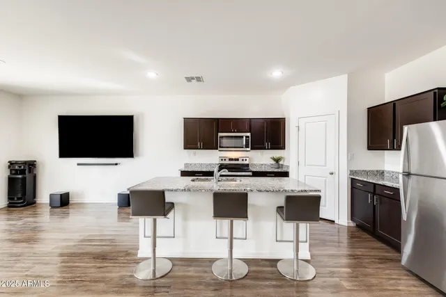 a kitchen with a stove a sink and a microwave