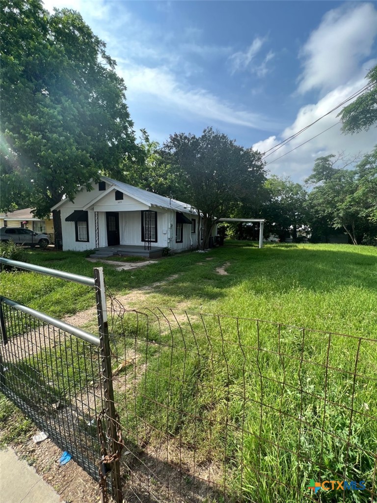 225 Lamar Street Luling, TX 78648 - Photo 2 of 12 a view of a house with a yard