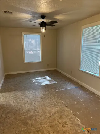 an empty room with a empty space and windows