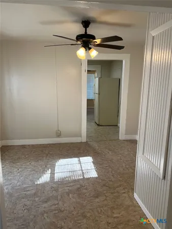 a view of a hallway with a chandelier fan
