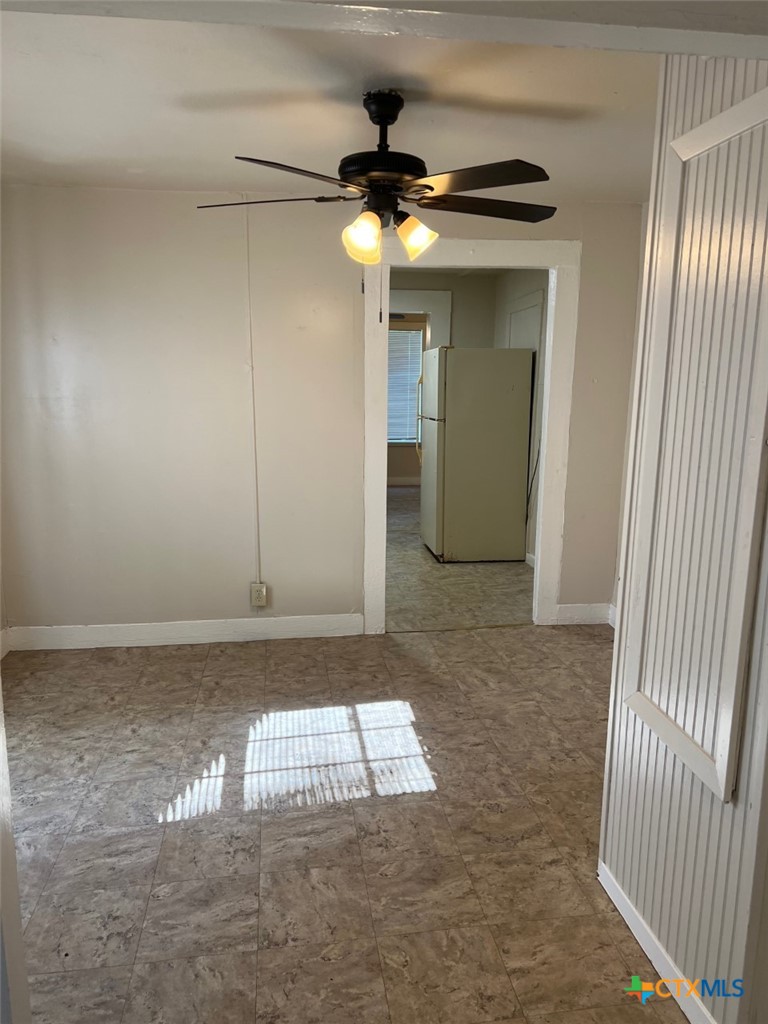 225 Lamar Street Luling, TX 78648 - Photo 7 of 12 a view of a hallway with a chandelier fan