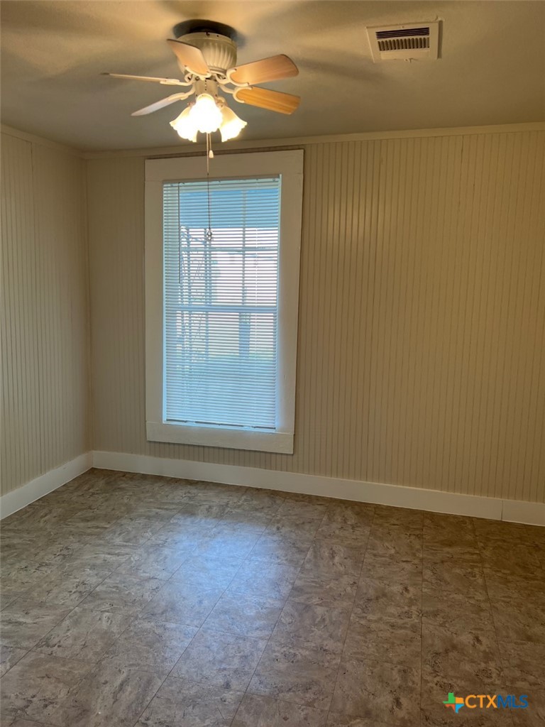 225 Lamar Street Luling, TX 78648 - Photo 8 of 12 a view of room with window and ceiling fan