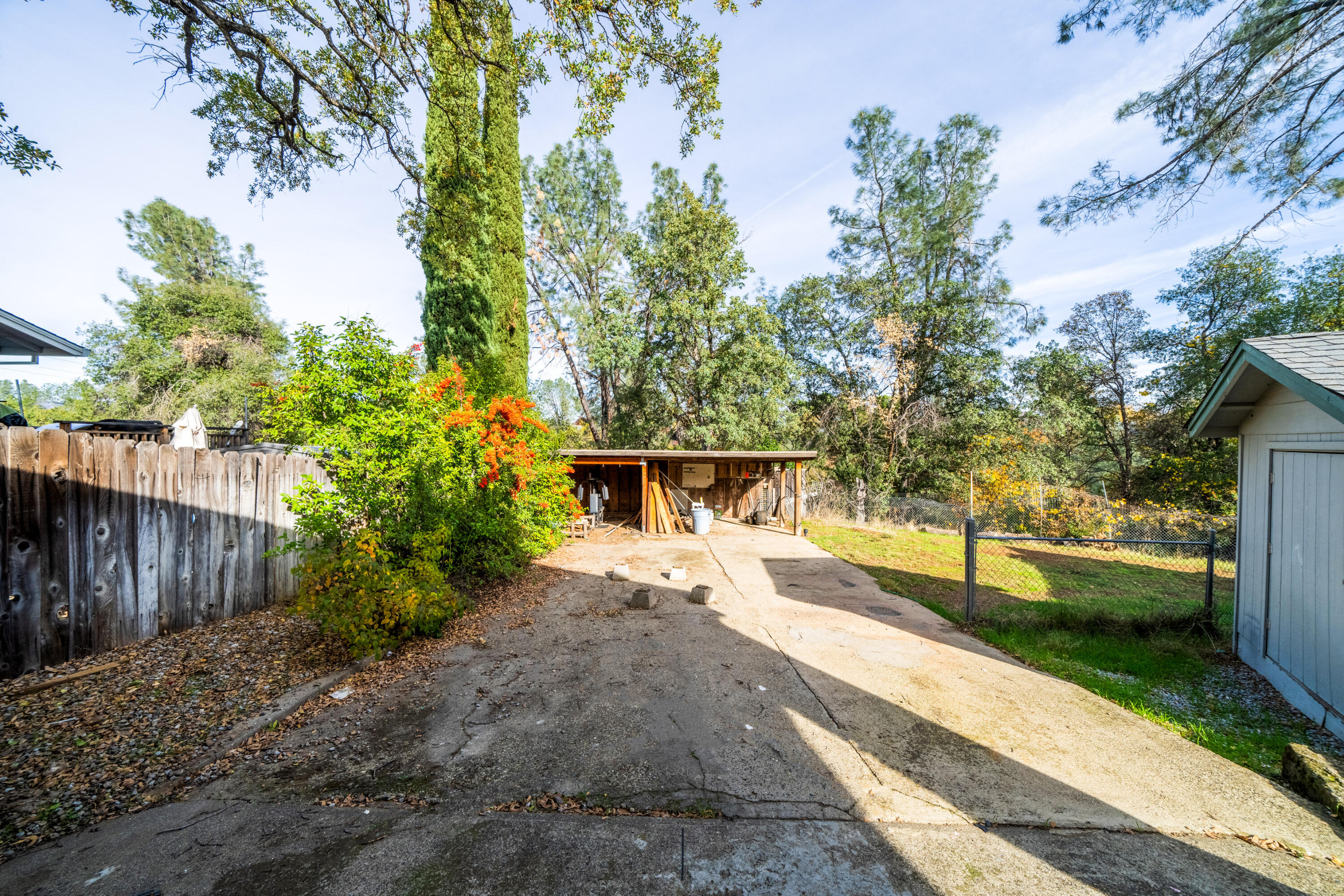 1330 Scenic Way Redding, CA 96001 - Photo 30 of 43 a view of a backyard with large trees and wooden fence