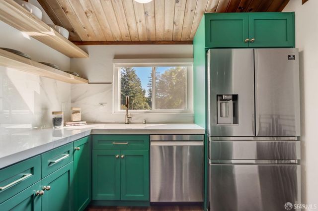 a kitchen with a refrigerator and a sink