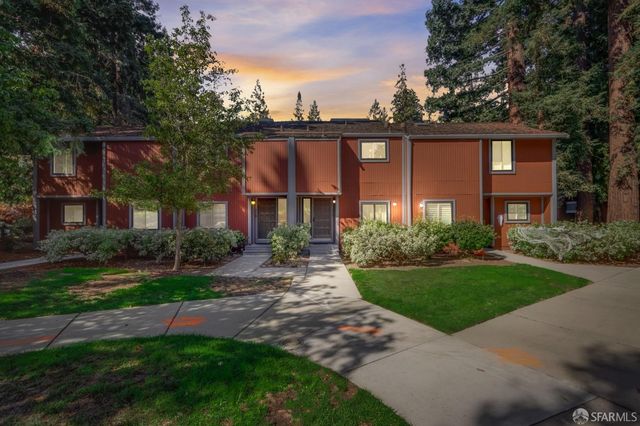 a front view of a house with a yard and outdoor seating