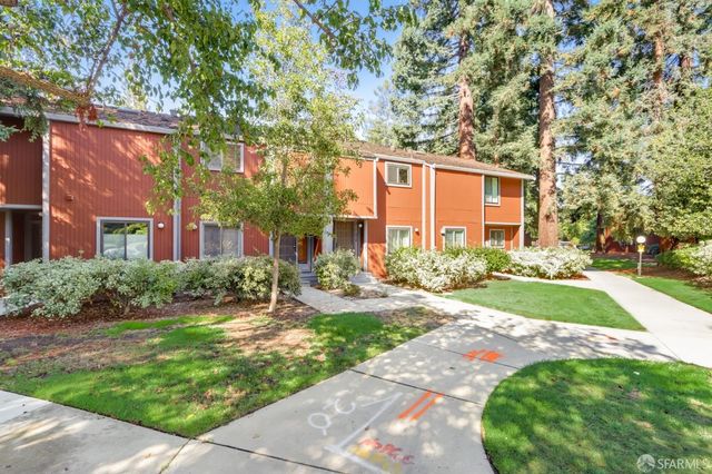 a front view of a house with yard and green space