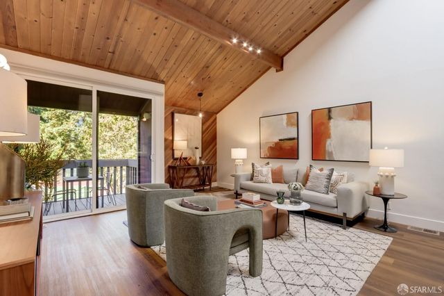 a living room with furniture and large windows