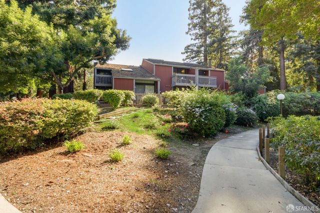 a view of a pathway with a house in the background