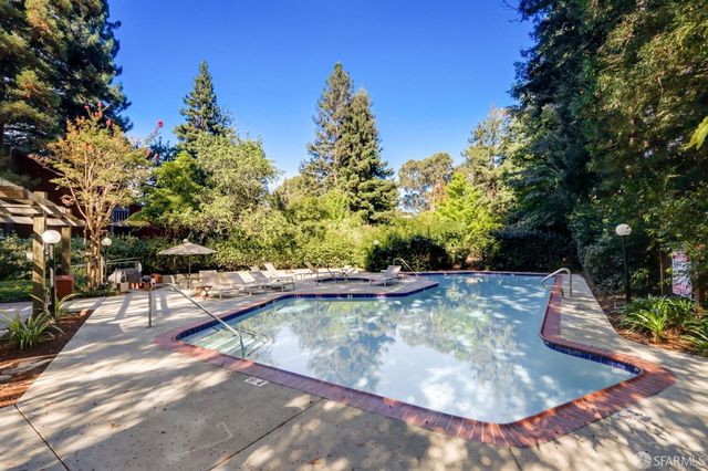 a view of a swimming pool with a patio