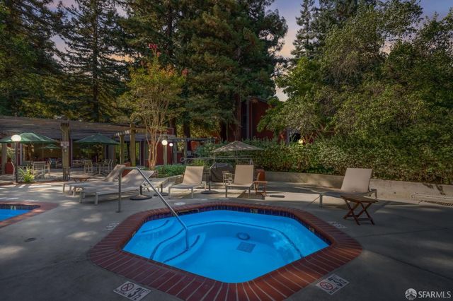 a swimming pool with outdoor seating and yard
