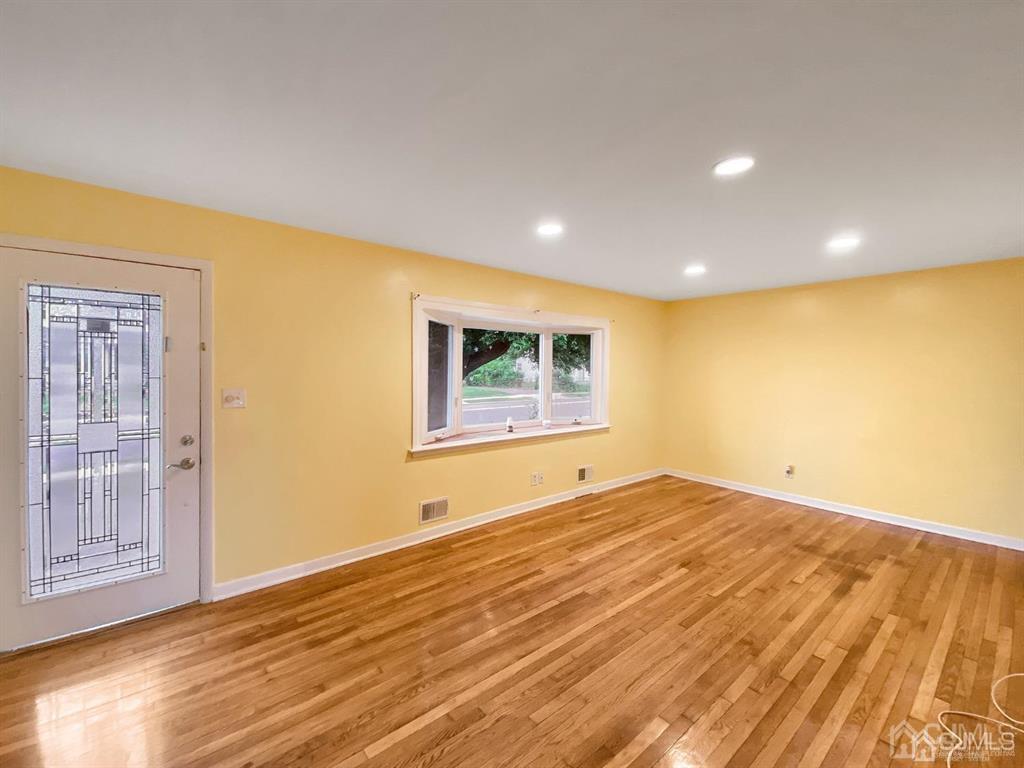 15 Racetrack Road East Brunswick, NJ 08816 - Photo 2 of 13 a view of an empty room with wooden floor and a window