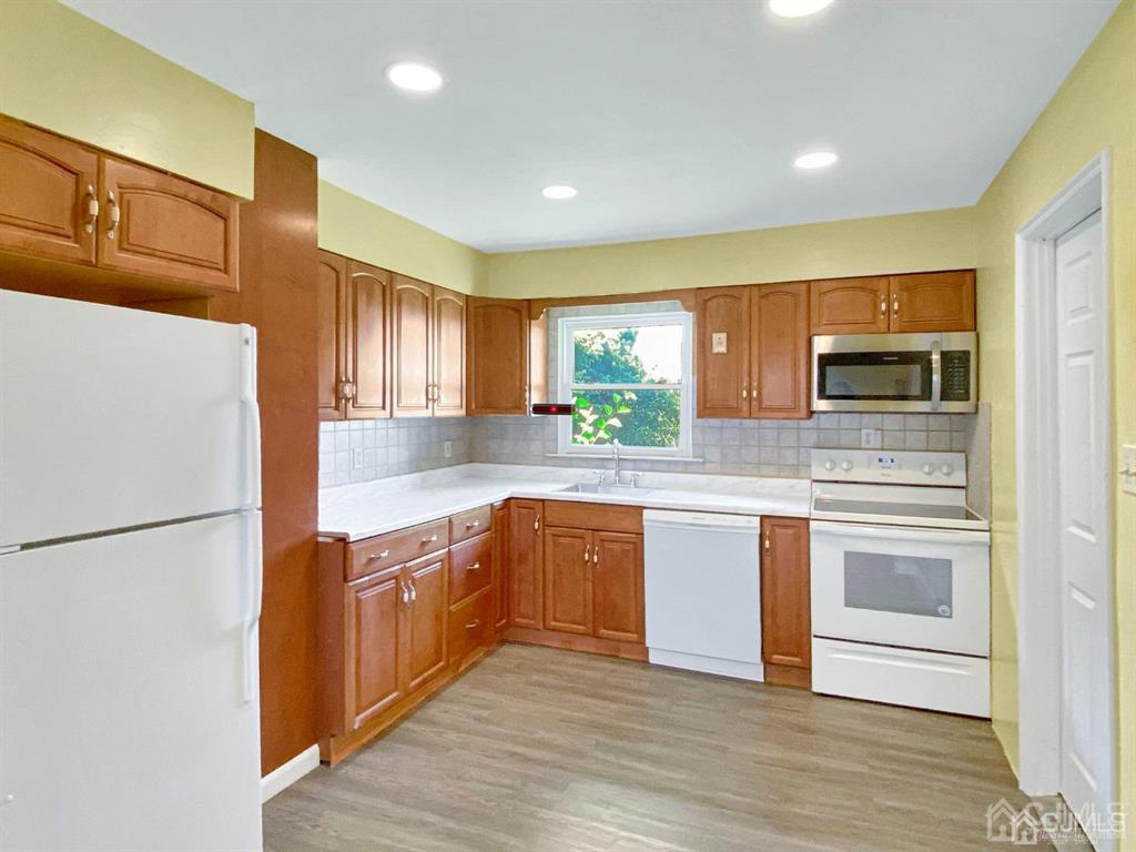 15 Racetrack Road East Brunswick, NJ 08816 - Photo 3 of 13 a kitchen with stainless steel appliances granite countertop a refrigerator a stove top oven a sink and dishwasher