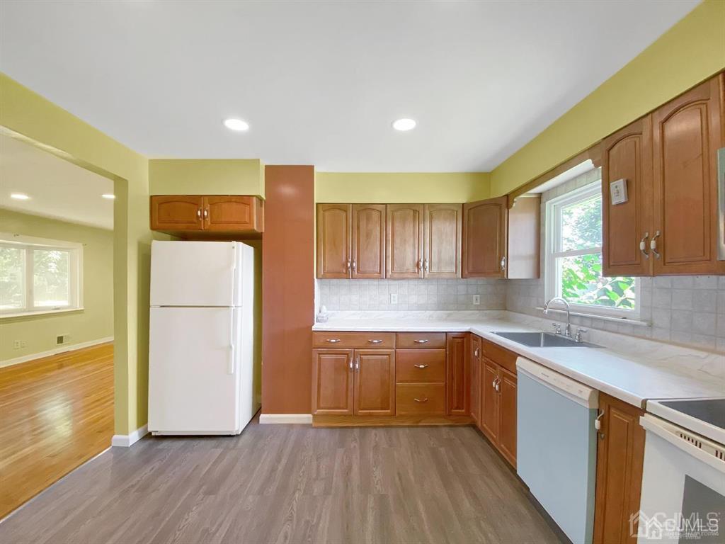 15 Racetrack Road East Brunswick, NJ 08816 - Photo 4 of 13 a kitchen with wooden floors and white appliances