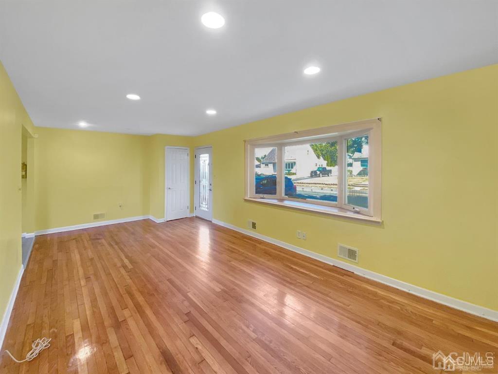 15 Racetrack Road East Brunswick, NJ 08816 - Photo 6 of 13 a view of empty room with wooden floor and fan