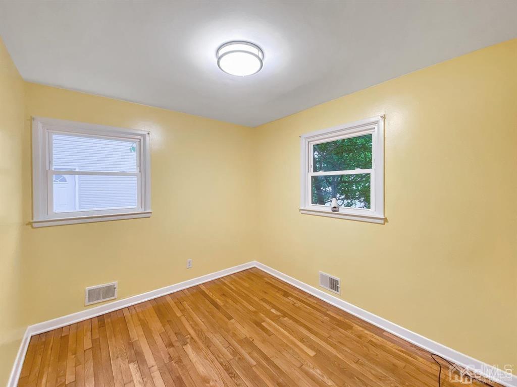 15 Racetrack Road East Brunswick, NJ 08816 - Photo 8 of 13 a view of a room with a wooden floor and a window