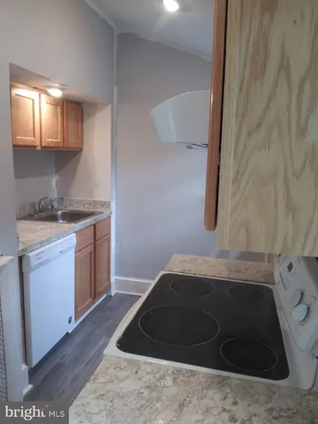 a kitchen with a sink and a stove top oven