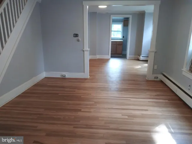 a view of a hallway with wooden floor