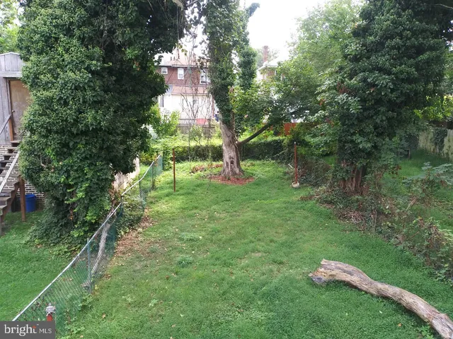 a lake view with a play ground and trees all around