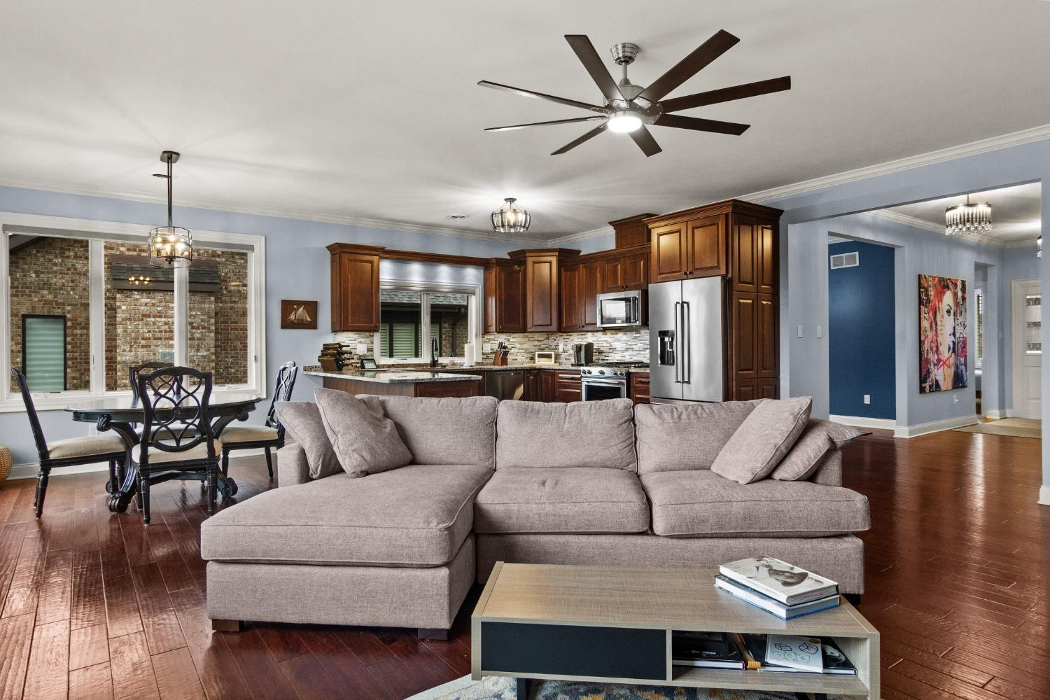 8415 Dancing Waters Lane St. John, IN 46373 - Photo 12 of 31 a living room with furniture kitchen and a chandelier